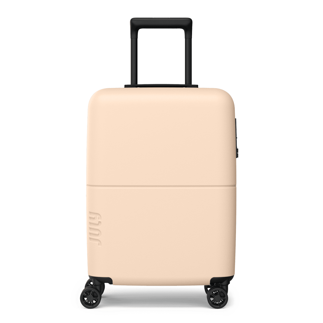 Beige suitcase with black wheels and handle on a transparent background