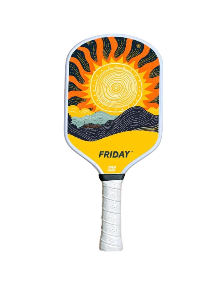 Pickleball paddle with sun and mountain design on a white background