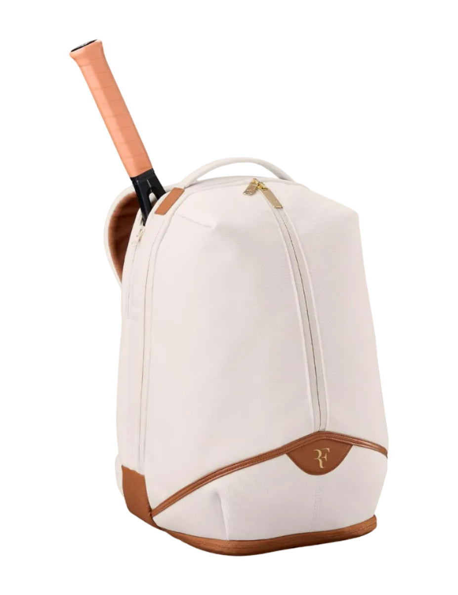 White tennis backpack with brown accents and a racket inside on a white background