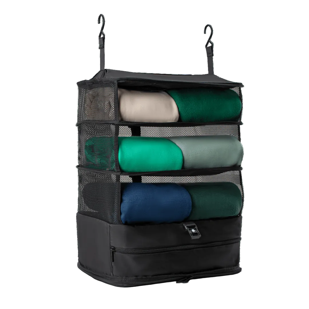 Black hanging organizer with folded clothes on a white background