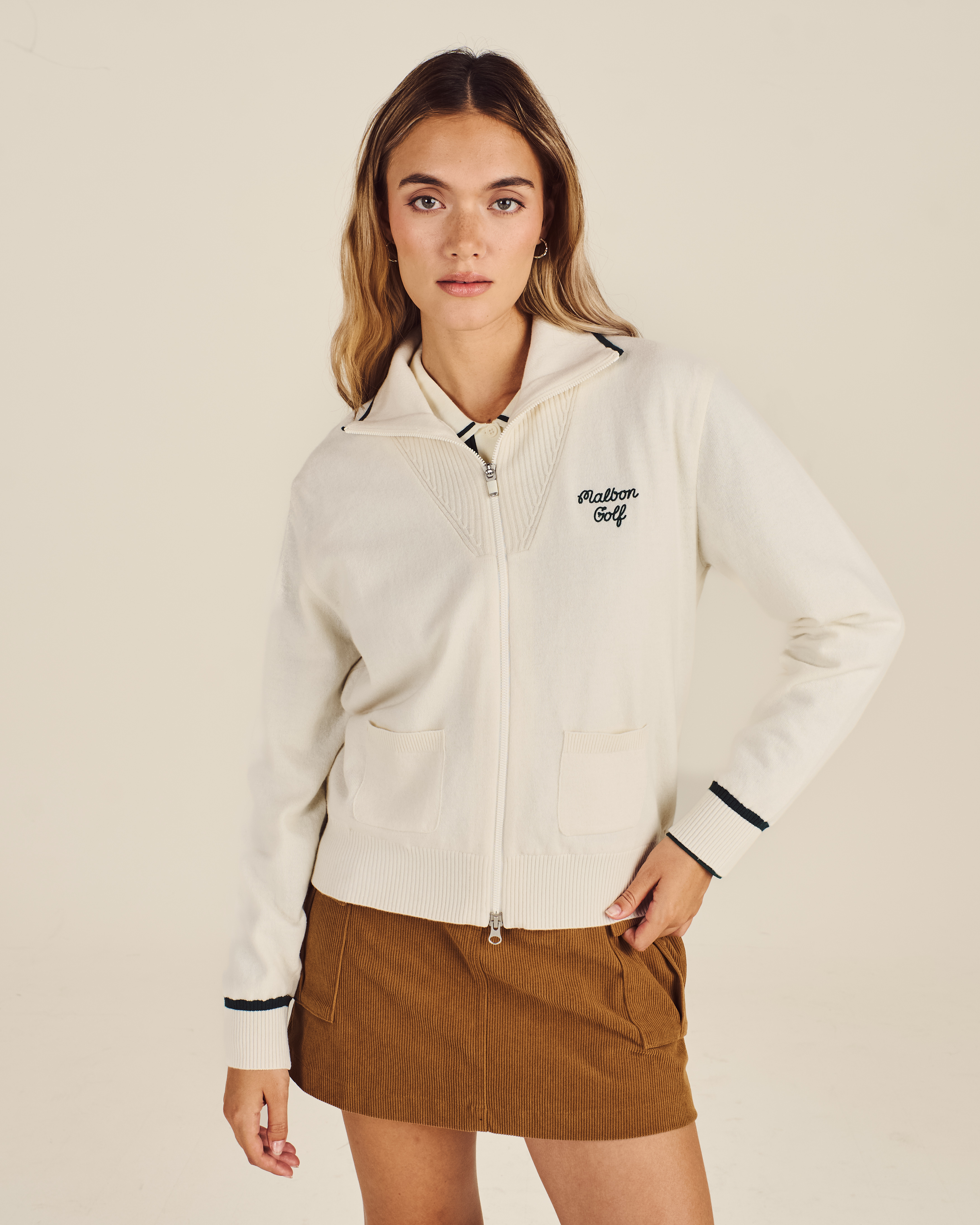 Model wearing Malbon Preserve Buckets Knit Windbreaker in pink oat