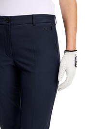 Navy golf pants with a white golf glove on a white background