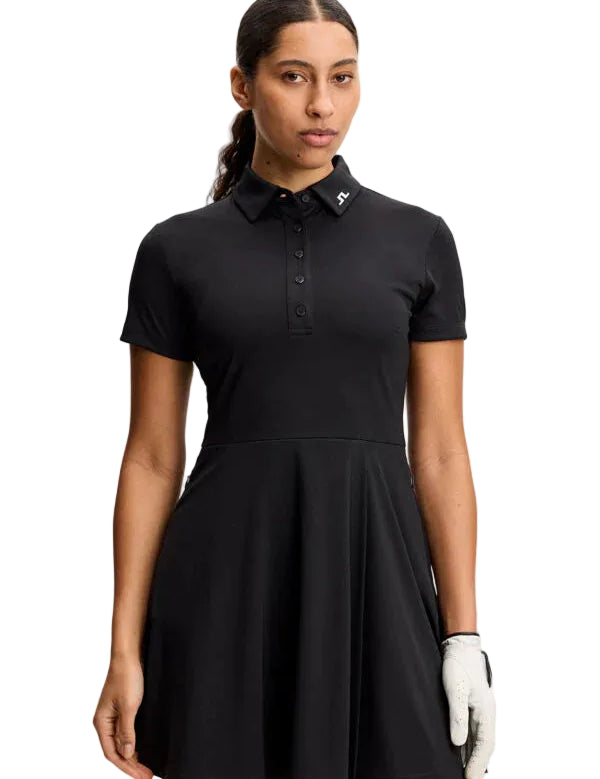 Woman wearing a black dress with a collar on a white background