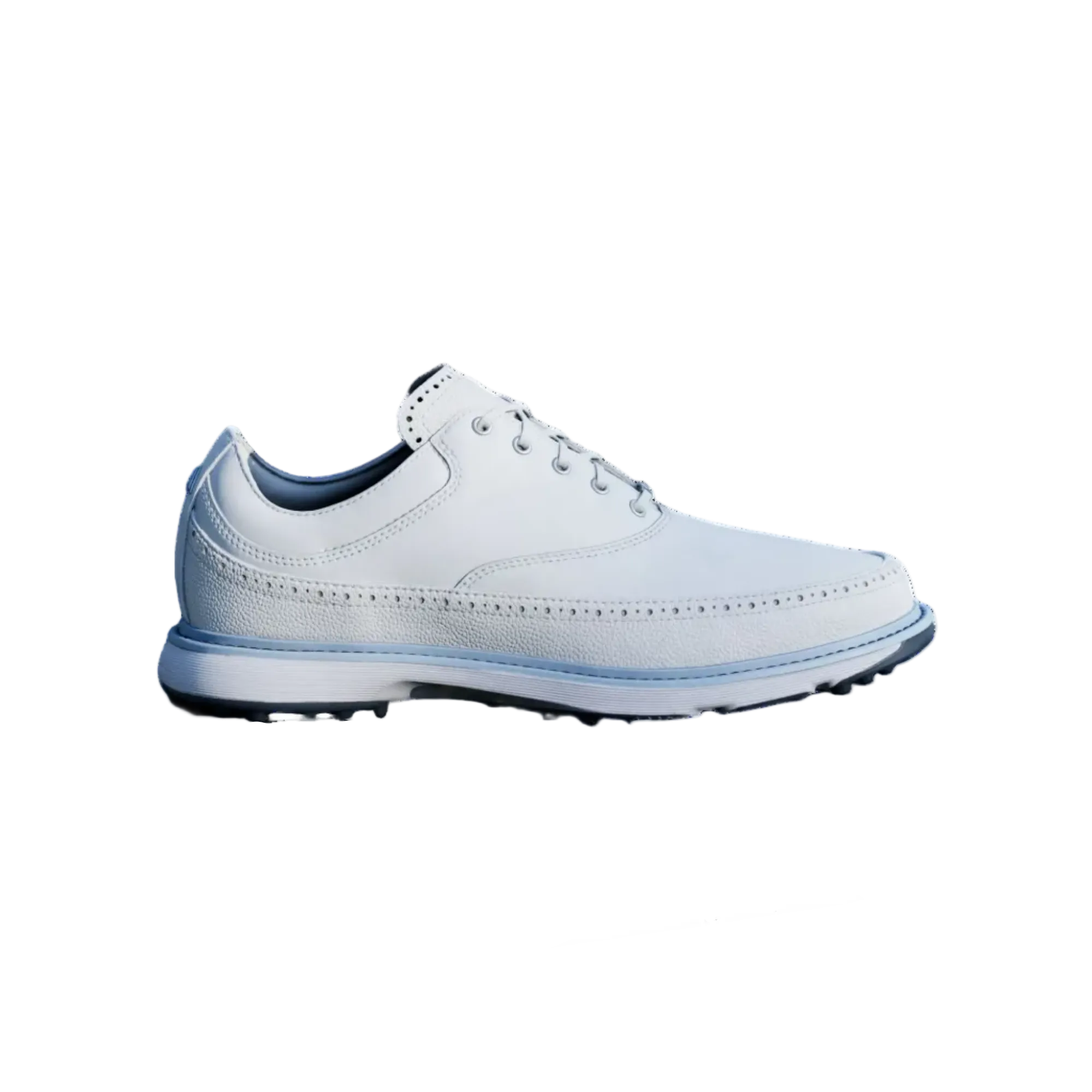 White golf shoe and ball on a green grass field with a flag in the background