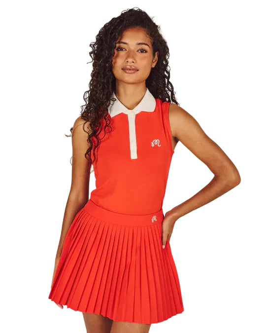 Woman wearing a red dress with a white collar against a beige background