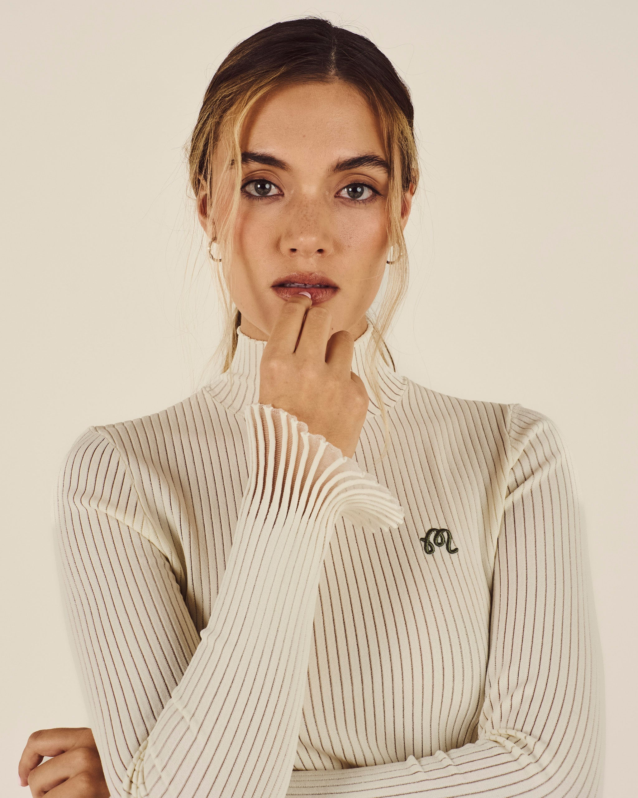 Model wearing Malbon Monika Turtleneck in cream