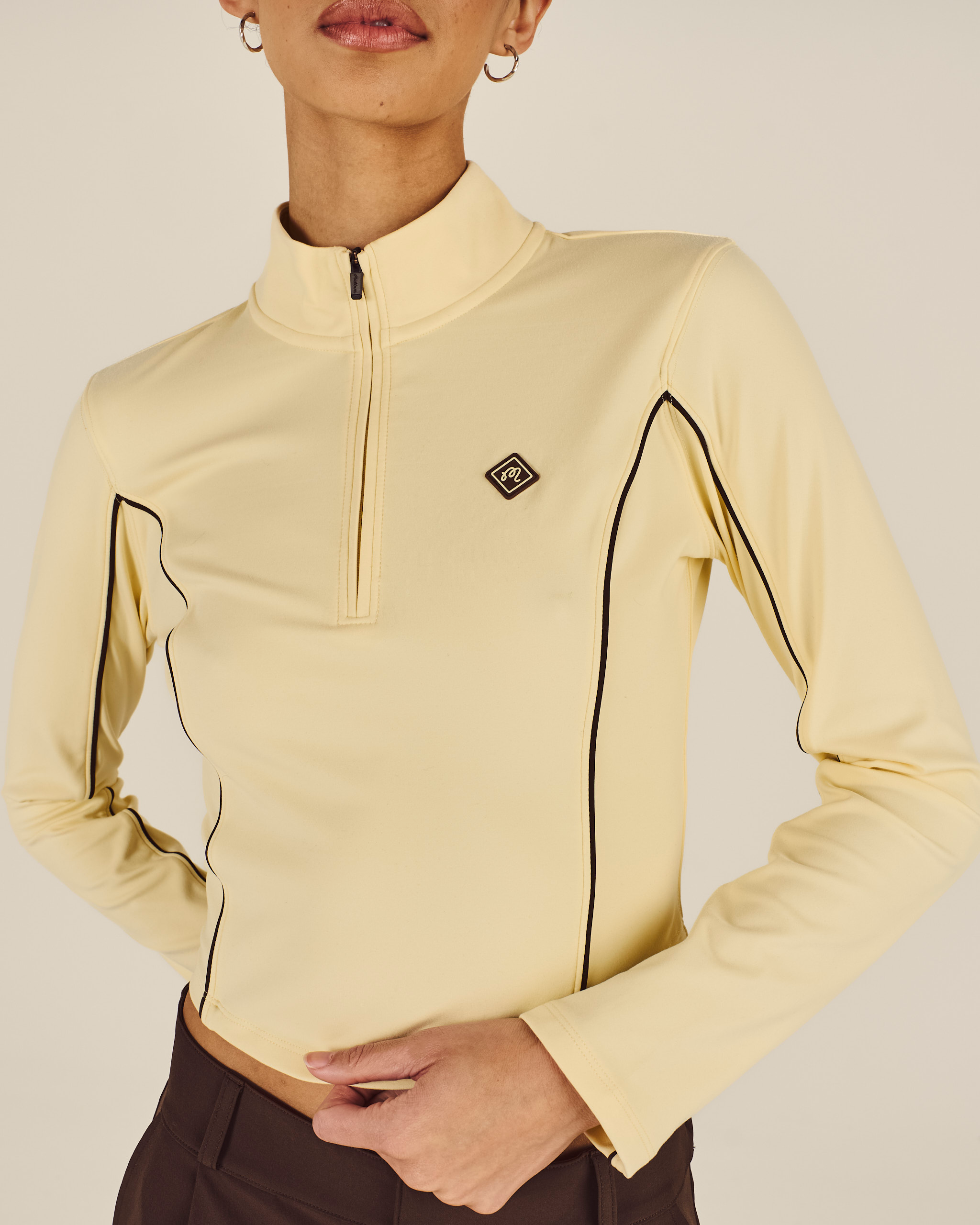 Model wearing Malbon Camila Mid Layer in light yellow