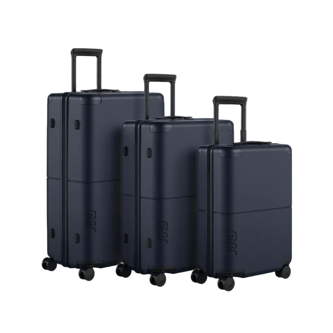 Three black suitcases of different sizes on a white background