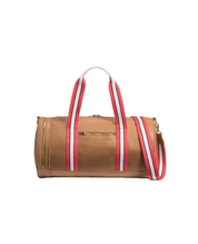 Brown duffel bag with red and white striped handles on a beige background