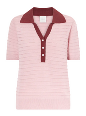 Pink knitted polo shirt with a maroon collar on a light gray background
