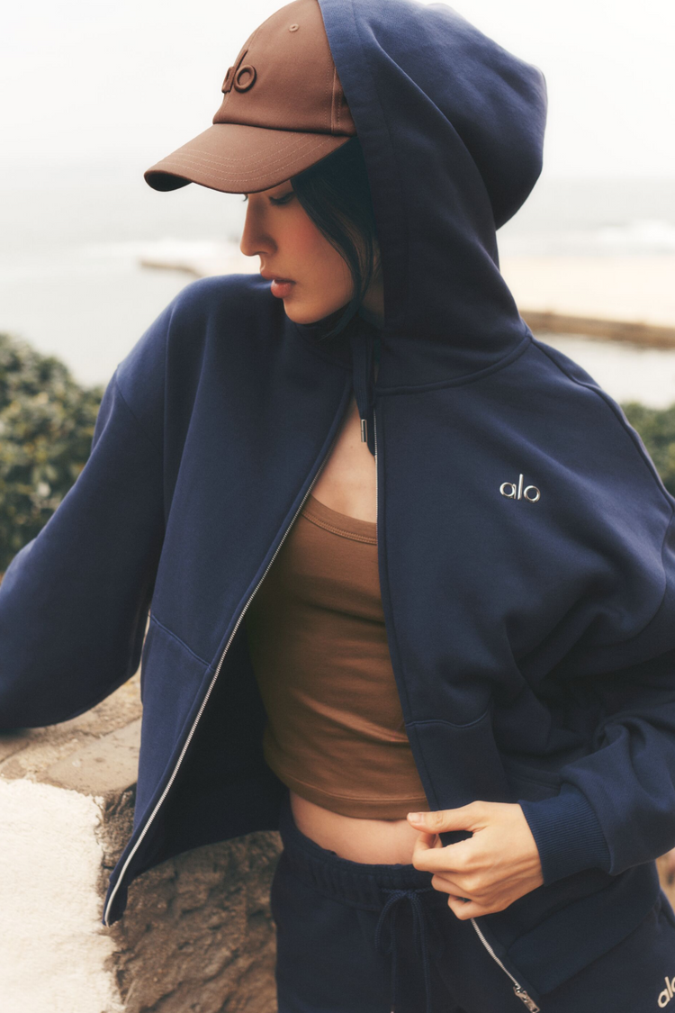 Model wearing Alo Yoga Accolade Full Zip Hoodie in navy