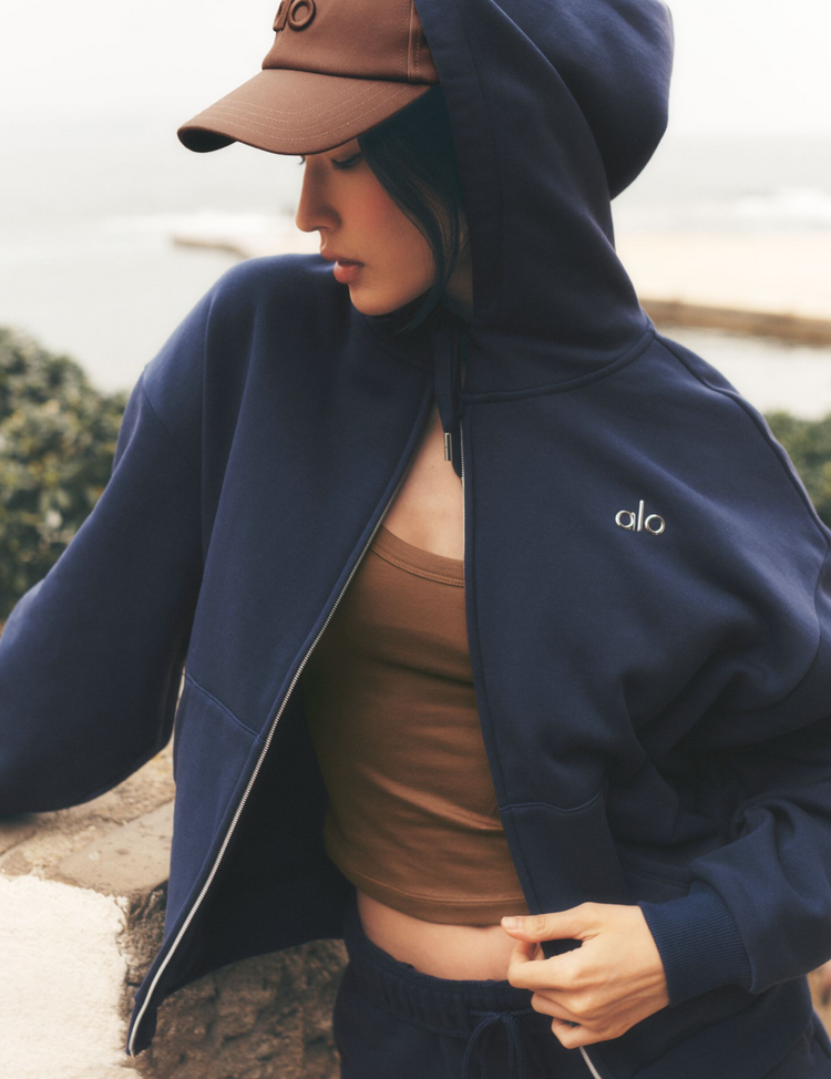 Model wearing Alo Yoga Accolade Full Zip Hoodie in navy