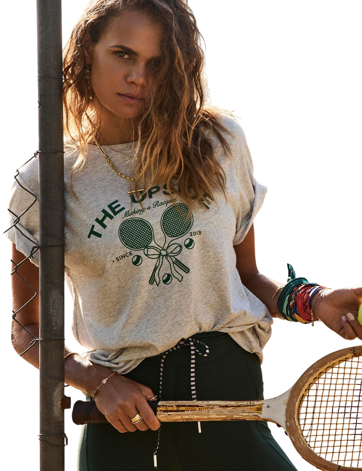Model wearing a tshirt with a tennis racquet print in grey
