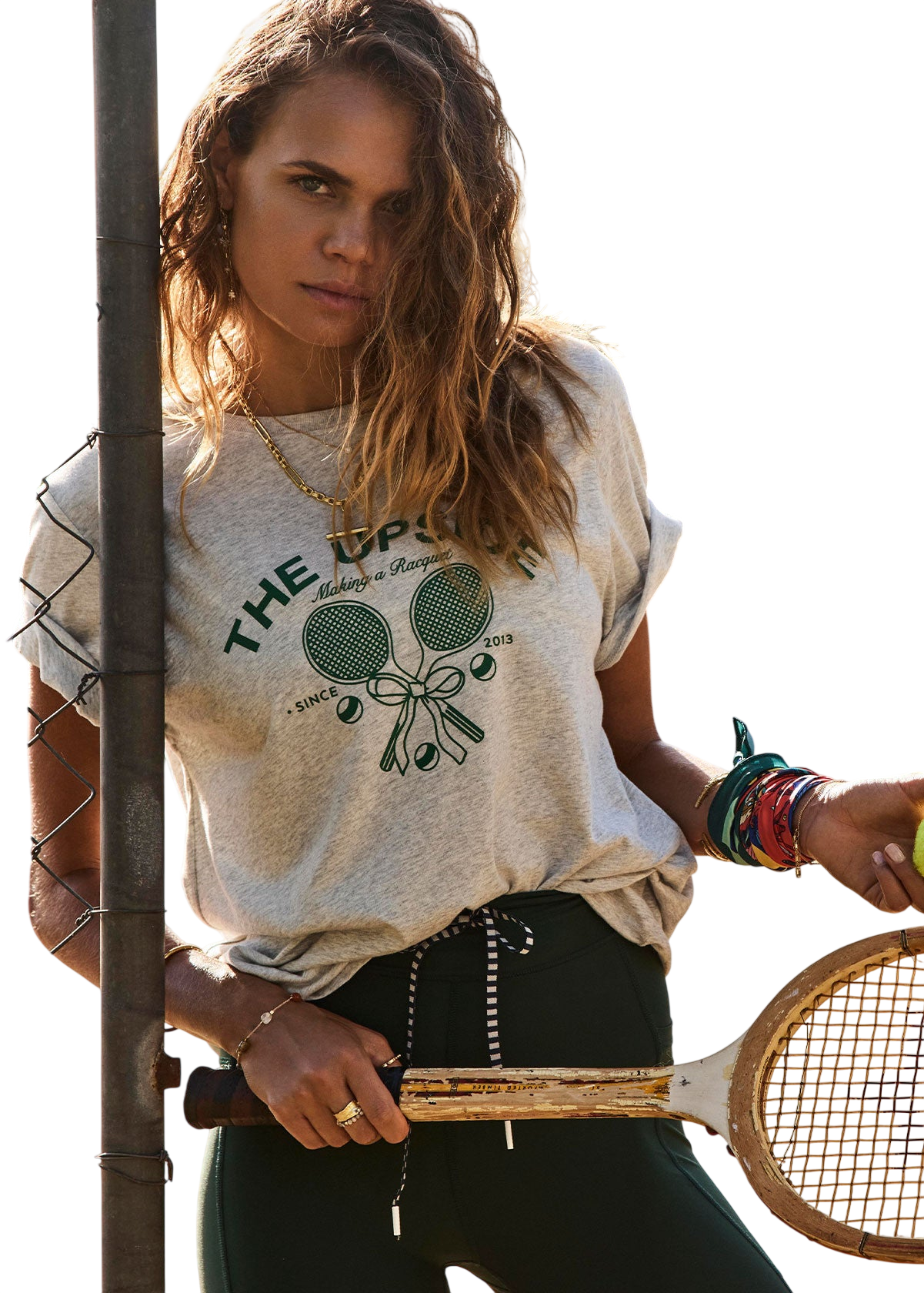 Model wearing a tshirt with a tennis racquet print in grey