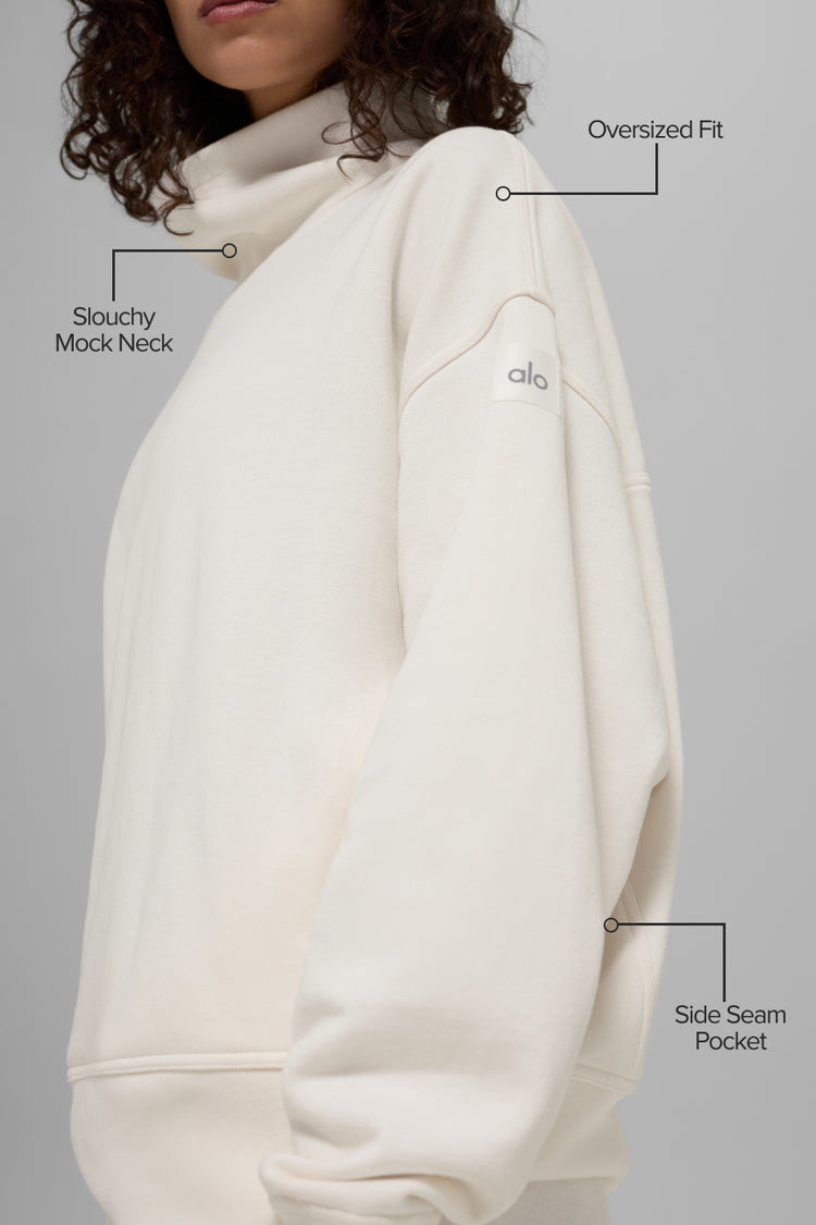 Model wearing Alo Yoga Hazy Mock Neck Pullover in ivory
