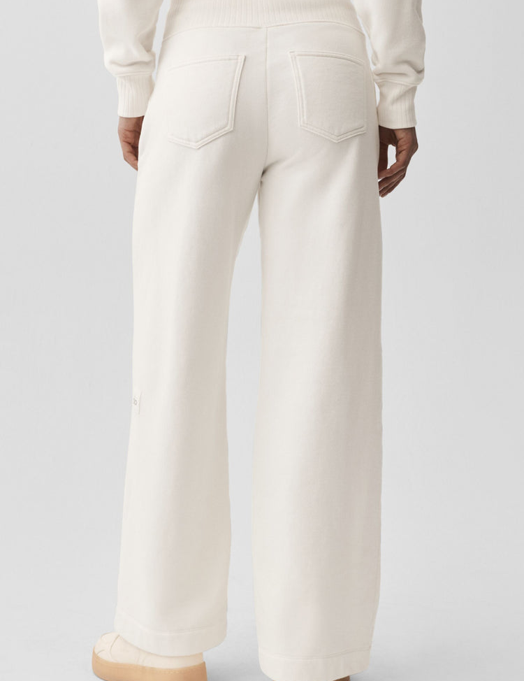 Model wearing Alo Yoga Serenity Wide Leg Sweatpant in ivory