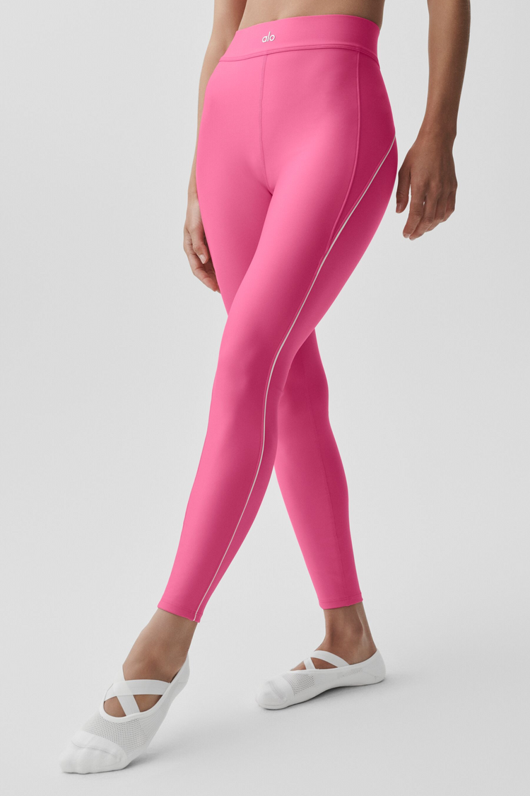 Model wearing Alo Yoga Airlift High-Waist 7/8 Speedwork Legging in taupe