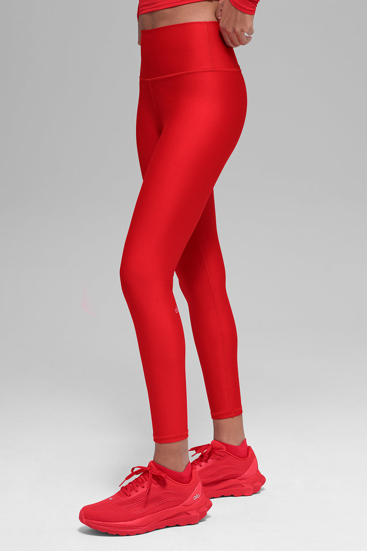 Model wearing Alo Yoga 7/8 High-Waist Airlift Legging in black cherry