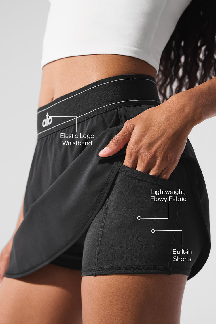Model wearing Alo Yoga Match Point Tennis Skirt