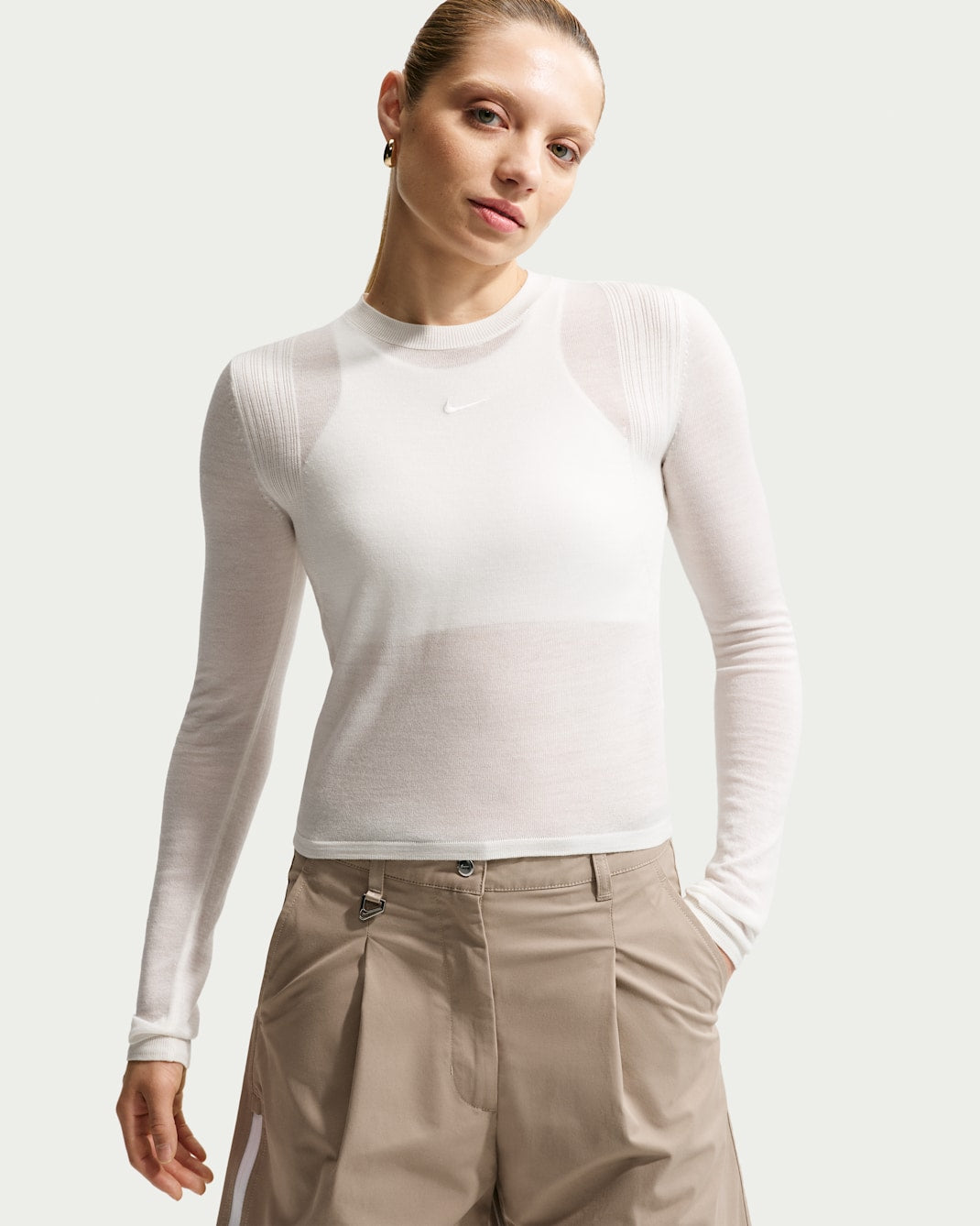 Black long-sleeve top with fitted silhouette, front view on white background