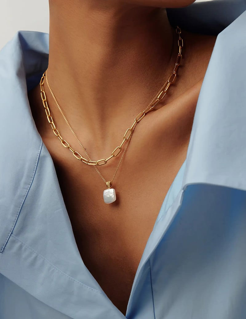 necklace on model with gold chain and pearl pendant 