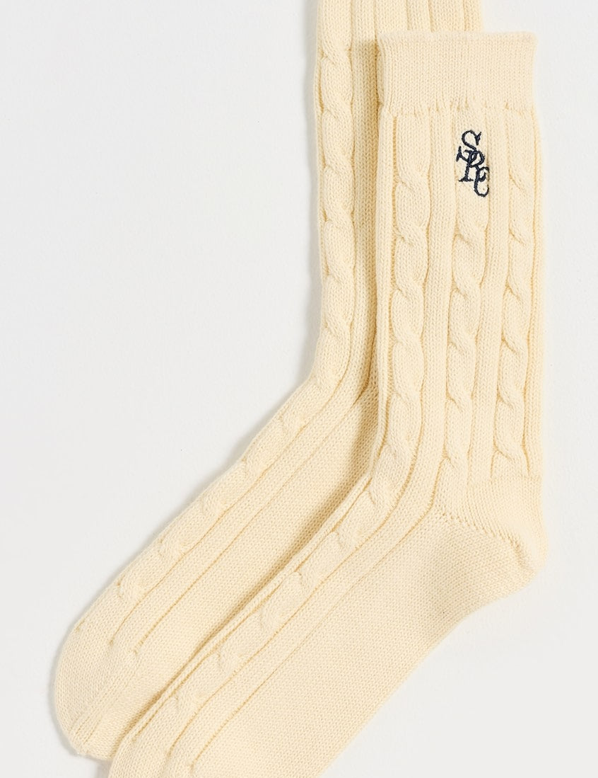 Sporty & Rich Cable Knit Socks laid flat on a white background