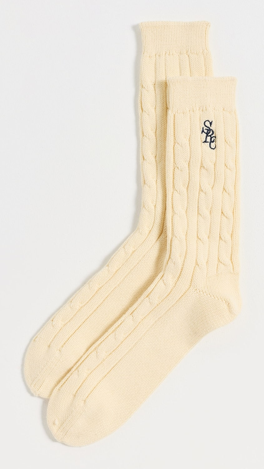 Sporty & Rich Cable Knit Socks laid flat on a white background