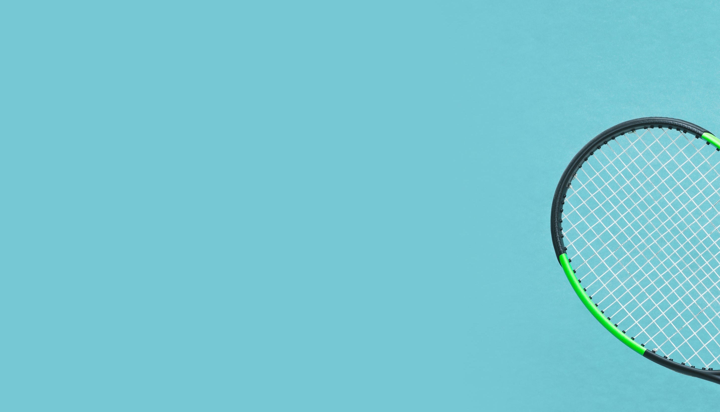 A tennis racket with a black frame and bright green string bed, positioned on the right side against a solid light blue background.