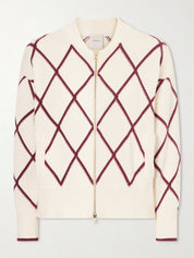 Cream-colored sweater with red diamond pattern on a light gray background