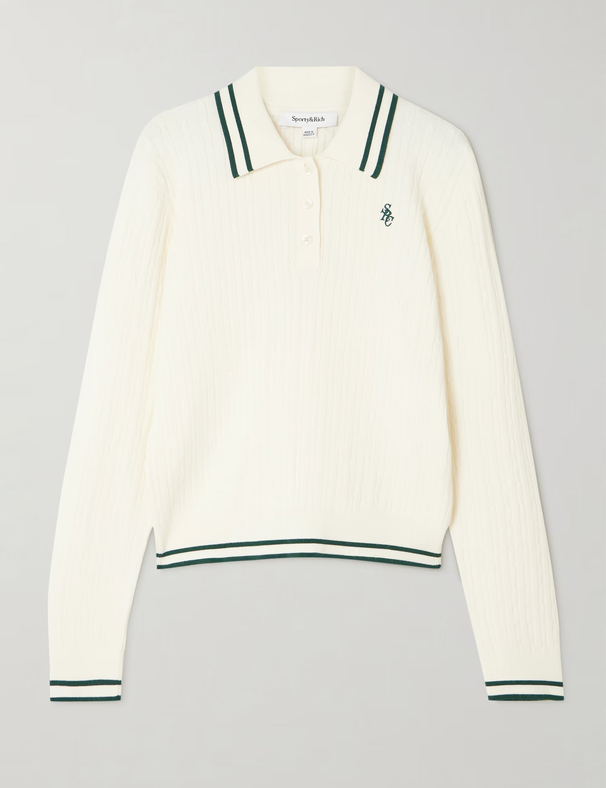 White long-sleeve polo shirt with green accents on a gray background